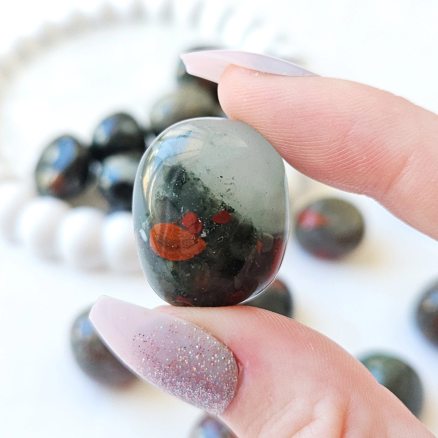 African Bloodstone Tumbled Stones In Hand