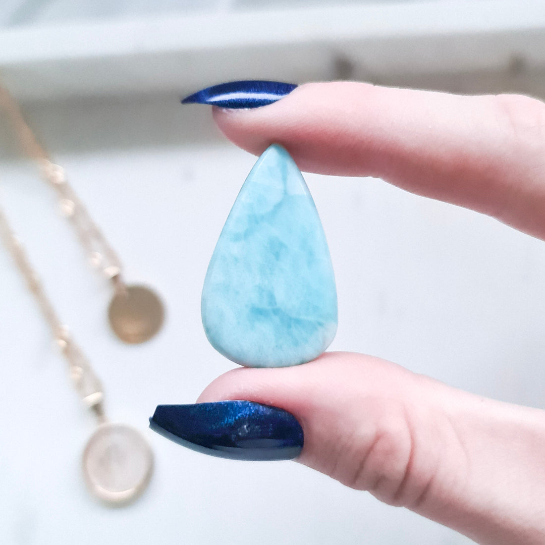 Larimar tear drop cabochon showcasing its serene blue colour and unique patterns